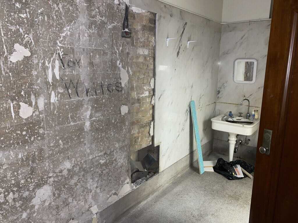 Handwritten sign that reads “For Whites” on a previously hidden interior wall of Battle Hall, 2021.