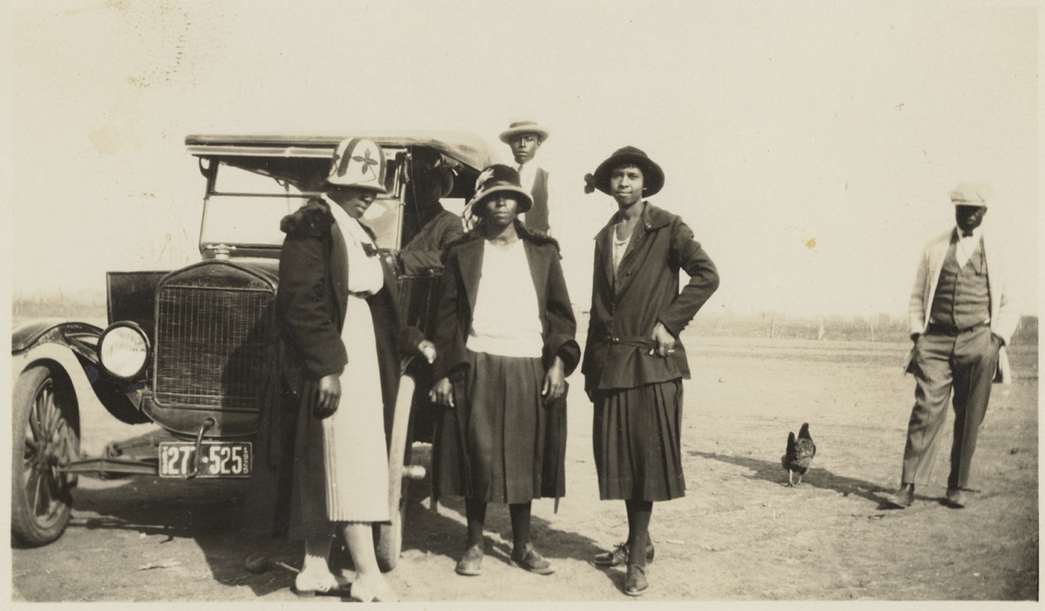 Five people posing in front of a Ford Model T. Rhone Family Papers. di_10766