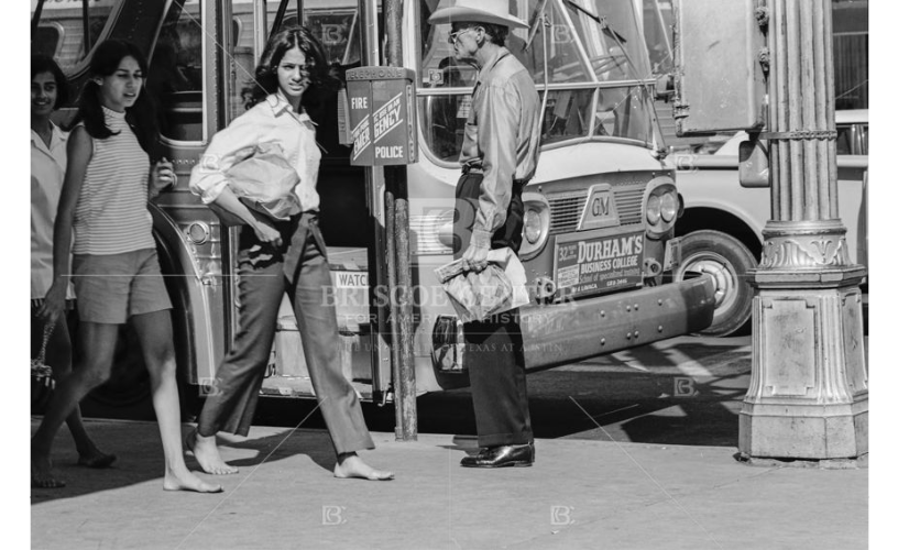 Photograph of barefoot girls walking in downtown Austin, circa 1965-1970
